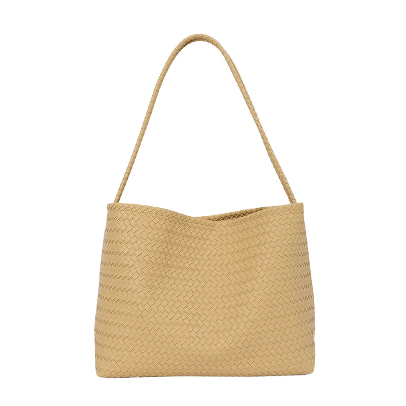 A beige woven straw bucket shoulder bag with a long strap.