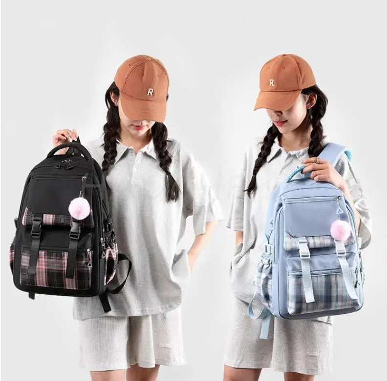 Two girls wearing light gray dresses holding Capybara Print Canvas backpacks