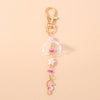 Gold-toned starfish keychain with pink and clear pearl accents