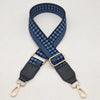 A dark blue and black checkered braided nylon bag strap with metal hooks.