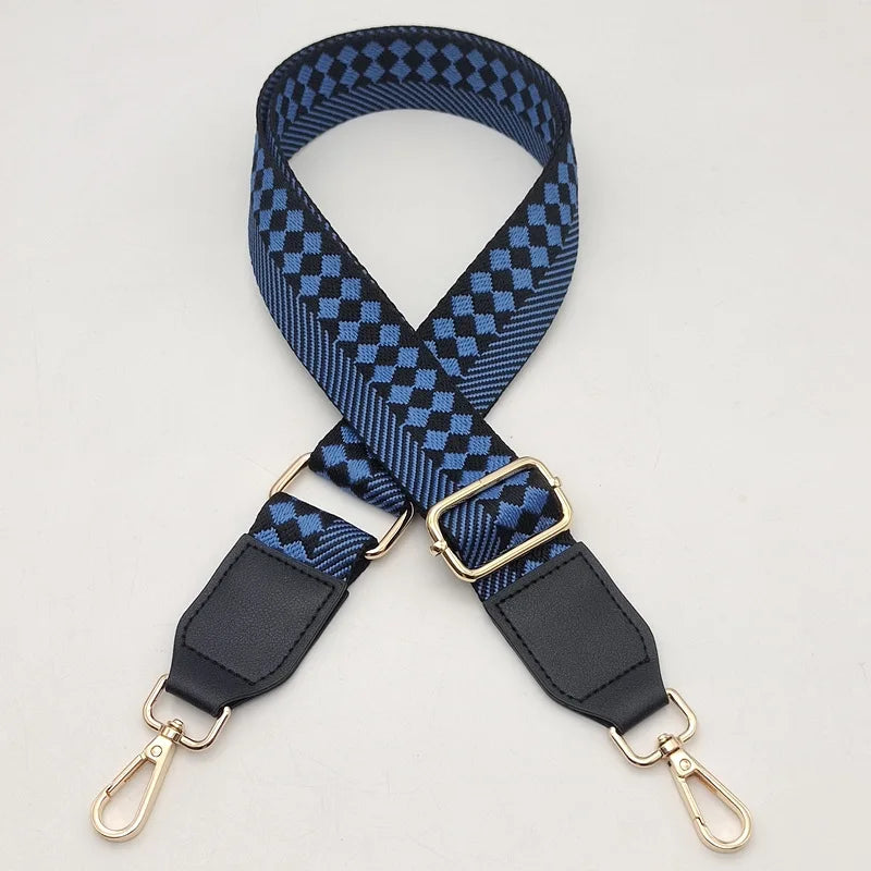 A dark blue and black checkered braided nylon bag strap with metal hooks.