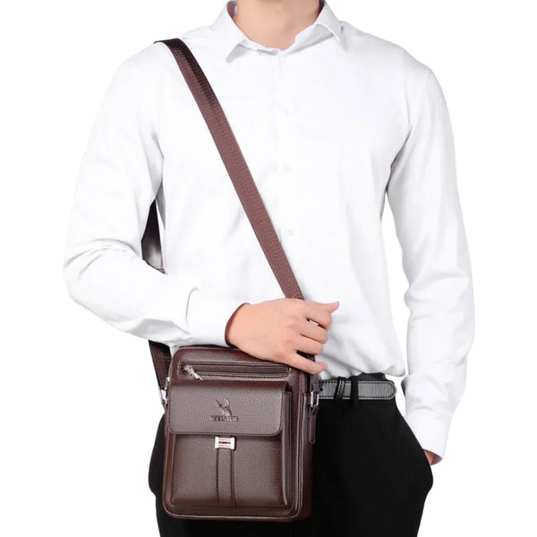 A brown vintage PU leather crossbody messenger bag worn by a man in a white shirt and black pants.