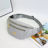 A light gray nylon crossbody fanny pack is shown lying on a white surface.