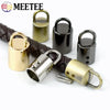 A collection of metal cord lock buckles in various finishes and sizes for bags, straps, and crafts.