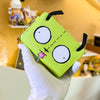 A bright lime green cartoon character coin purse wallet with large black eyes and a stitched outline is held by a hand.