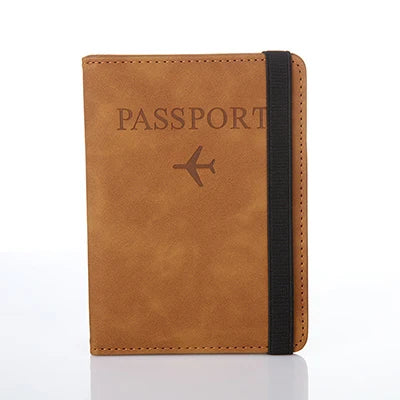 A brown leather passport organizer with a black strap and an airplane icon embossed on the cover.