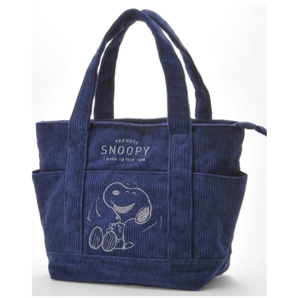 A navy blue canvas shoulder bag featuring a Snoopy cartoon design.