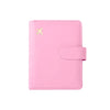 A pink leather passport organizer with a flap closure and an embossed airplane symbol.