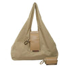 A beige foldable mini keychain tote bag with a flap closure and leather accents.