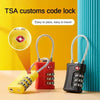 A set of TSA customs code locks in yellow and red colors displayed on a wooden surface.