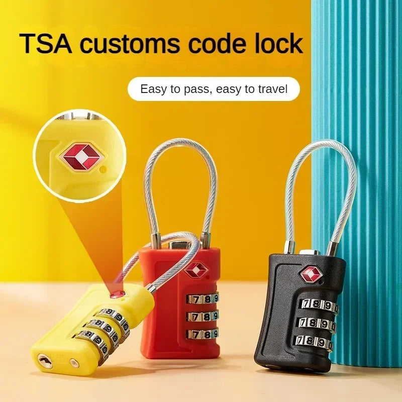 A set of TSA customs code locks in yellow and red colors displayed on a wooden surface.