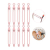A set of pink silicone cable ties and cord organizers shown in various sizes and angles.