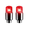 A pair of red LED tire valve stem lights with silver bases.
