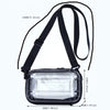 A clear plastic shoulder crossbody cosmetic bag with black straps and a rectangular design.
