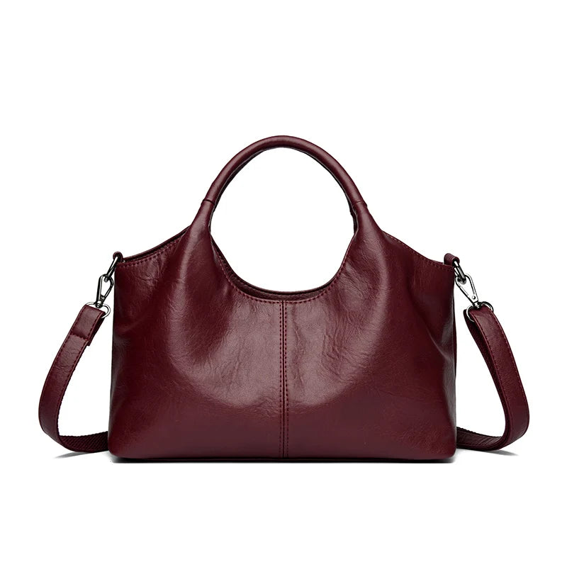A deep burgundy leather women's casual crossbody shoulder bag with a zip closure.