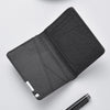 A black slim faux leather business card wallet shown from above.