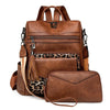 A brown retro PU leather travel backpack featuring a patterned fabric accent and tassel detail.