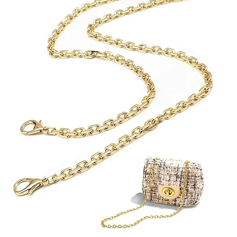 Gold stainless steel diamond-cut curb chain strap attached to a small woven clutch bag