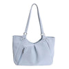 A light blue canvas tote bag with a slouchy shape and white polka dots.