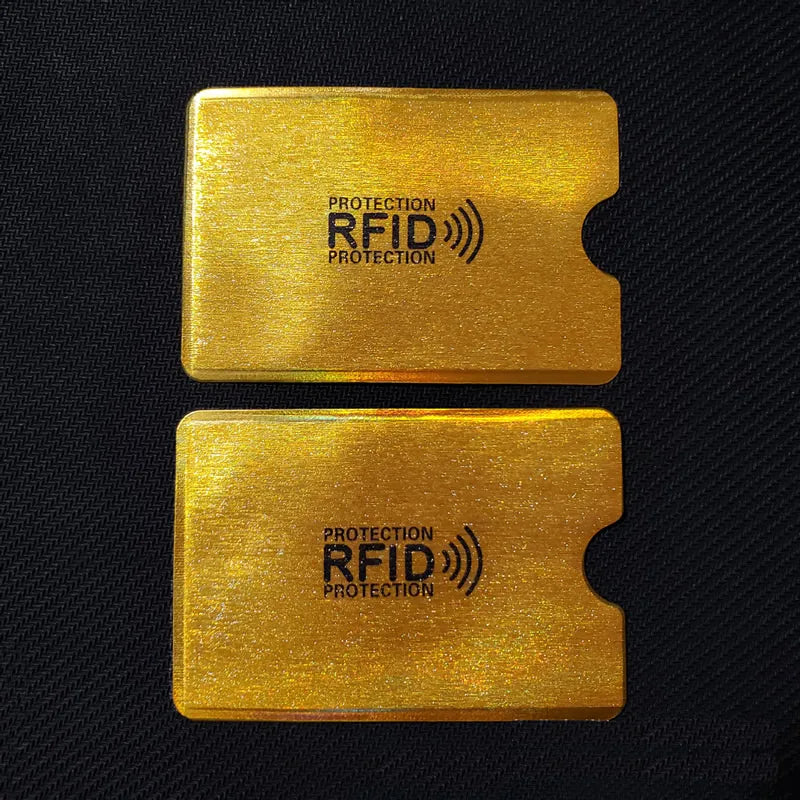 Two gold-colored cards with the text Protection RFID Protection printed on them.