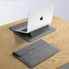 A silver laptop is placed inside a gray premium PU laptop sleeve on a wooden surface.