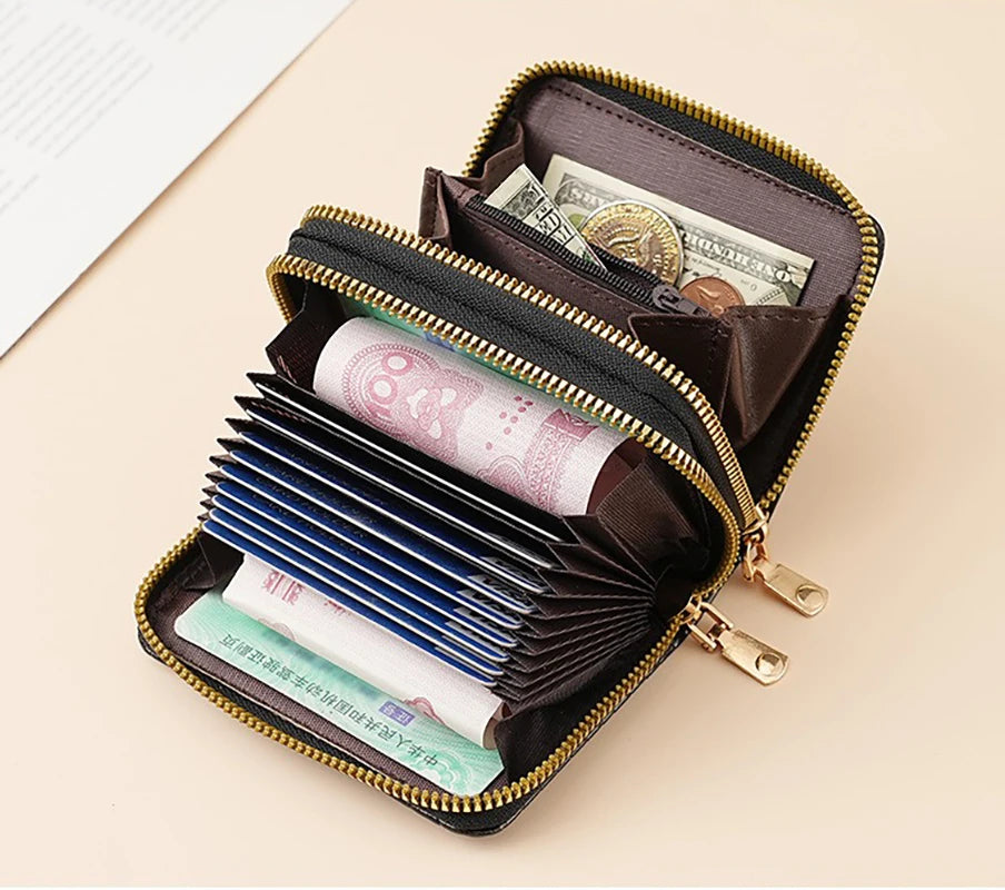 A brown fashion PU leather double zipper wallet is open, displaying various banknotes and cards.