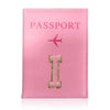 A pink leather passport holder with the word PASSPORT and a gold initial I embossed on it.