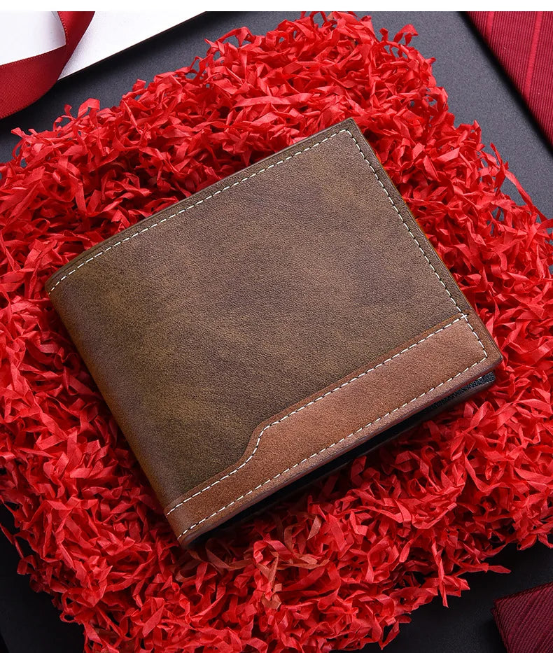 A brown PU leather men's wallet with an ID card holder resting on a vibrant red shredded fabric.