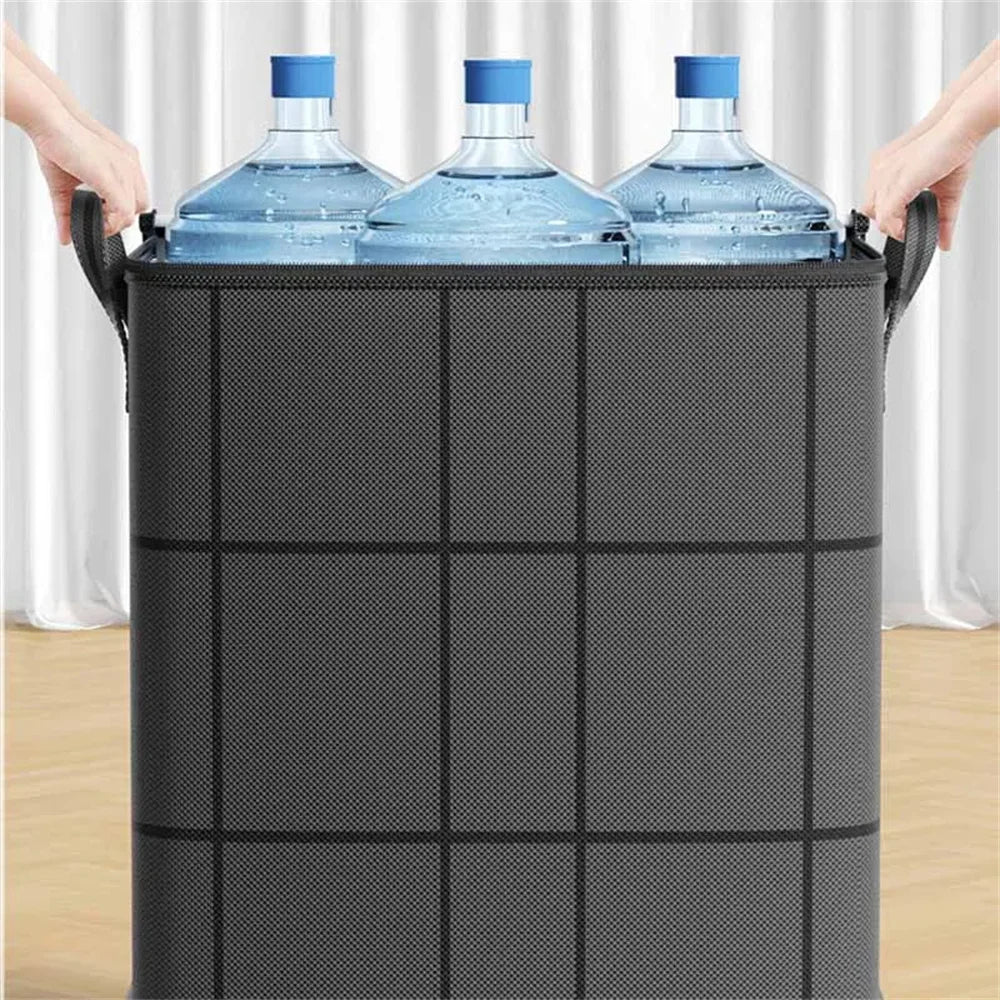 Hands are placing bottled water into a large black non-woven storage bag.
