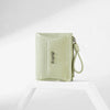 A light green PU leather mini wallet with a stitched detail and a leather strap is displayed on a white surface.