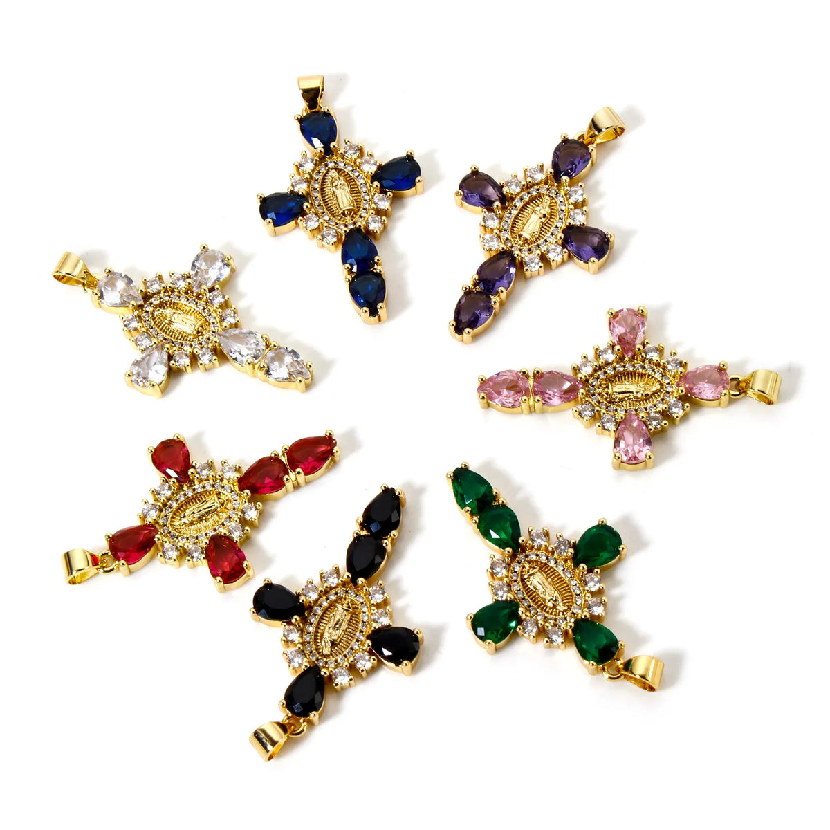 A collection of gold-plated cross and Virgin Mary charm pendants featuring various colored gemstones like blue, purple, clear