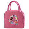 A pink insulated canvas lunch bag featuring a floral butterfly design.