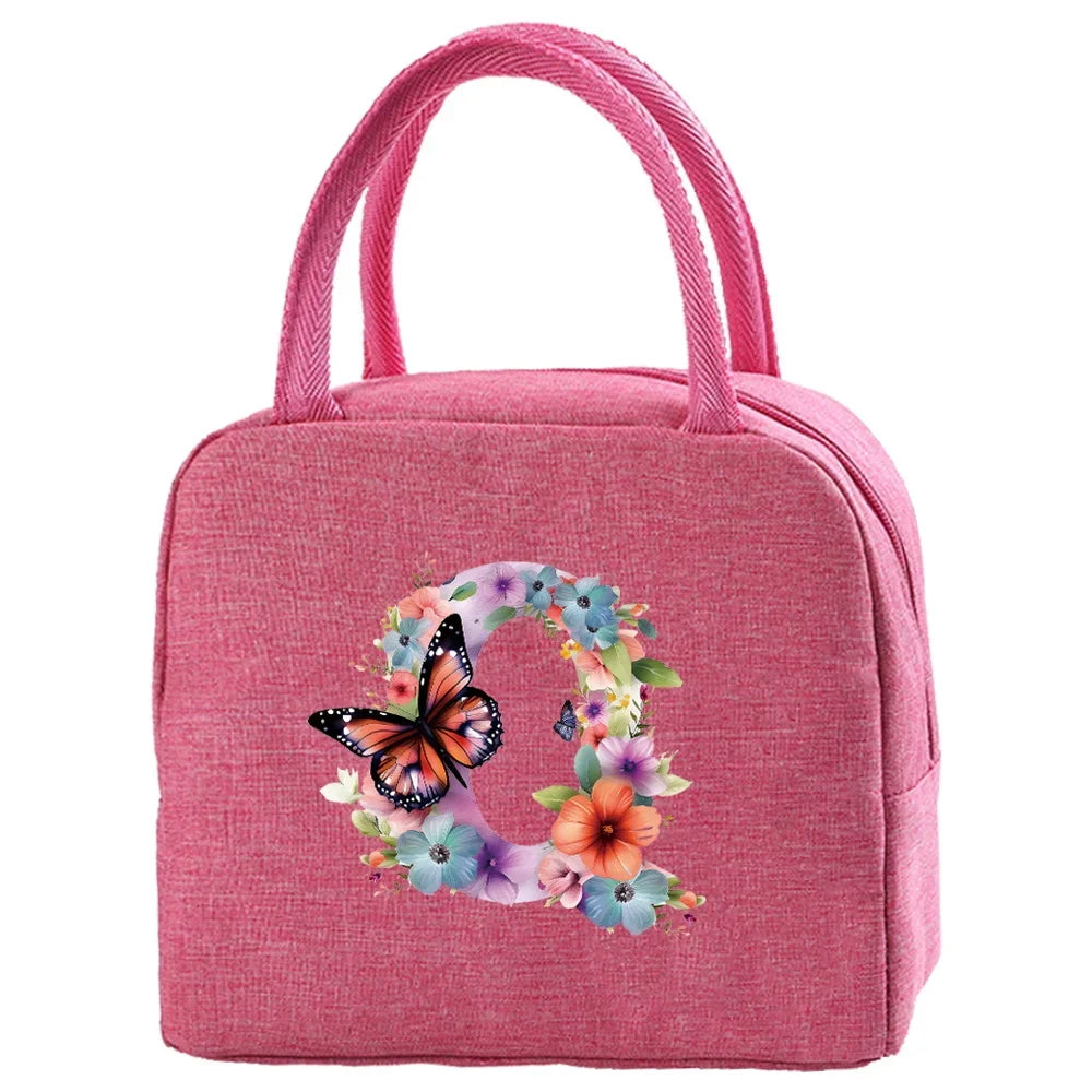 A pink insulated canvas lunch bag featuring a floral butterfly design.