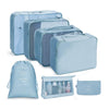 A set of light blue fabric storage organizers including zippered pouches and a drawer organizer.