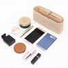 A collection of felt bag inserts and accessories including a zippered organizer, a pen, and a small notebook.