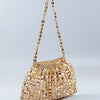 A handmade dumpling bag made of gold and silver beads, featuring a textured, shimmering surface.