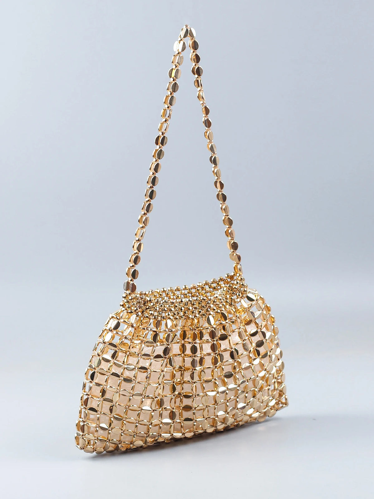 A handmade dumpling bag made of gold and silver beads, featuring a textured, shimmering surface.