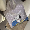 A light gray canvas shoulder bag featuring a Snoopy cartoon design with white stars and blue waves.