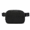 Black fleece crossbody belt bag with black strap and buckle.