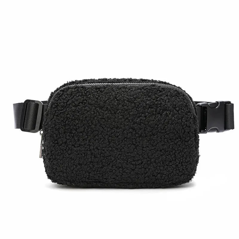 Black fleece crossbody belt bag with black strap and buckle.