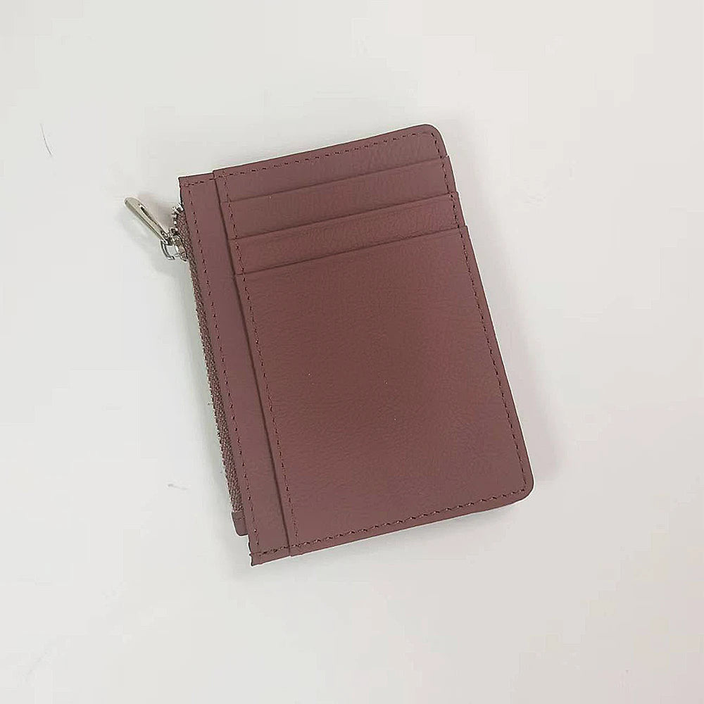 A mauve genuine leather zipper card holder and coin purse displayed on a white background.