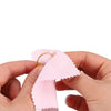 Hands holding a pink polishing cloth set for silver and gold jewelry