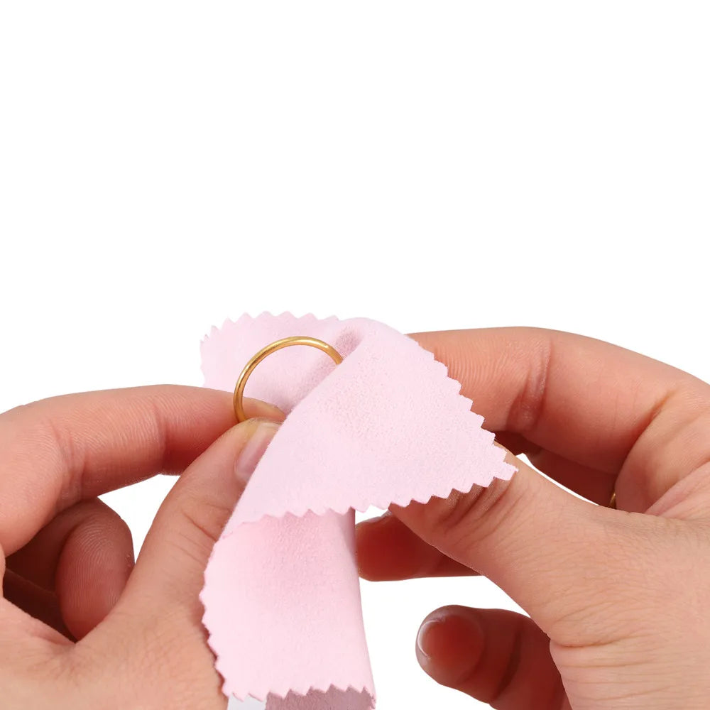 Hands holding a pink polishing cloth set for silver and gold jewelry