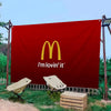 A large red banner featuring the McDonald's logo and the text I'm lovin' it, displayed outdoors.