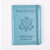 A light blue leather passport holder with embossed text and an eagle emblem.
