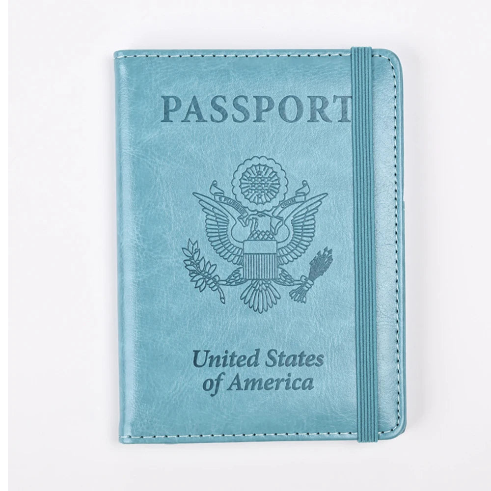 A light blue leather passport holder with embossed text and an eagle emblem.