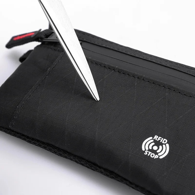 Black RFID blocking travel wallet with a silver knife visible on top