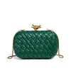 A dark green handwoven clutch evening bag with gold hardware.