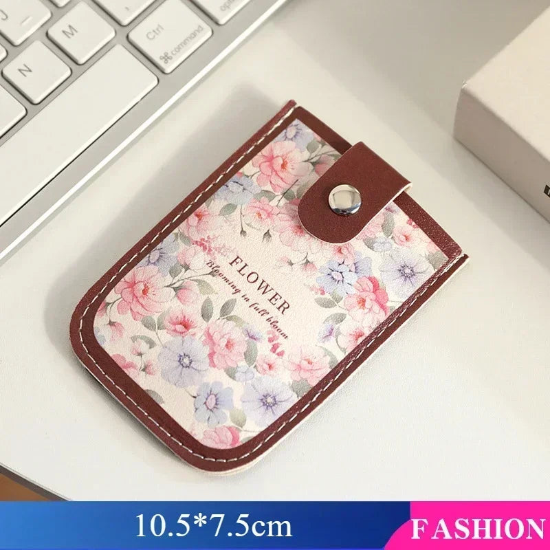 A brown leather-edged card wallet featuring a floral pattern with pink and purple flowers.