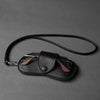 Black PU leather eyewear storage case with a leather strap and silver clasp.